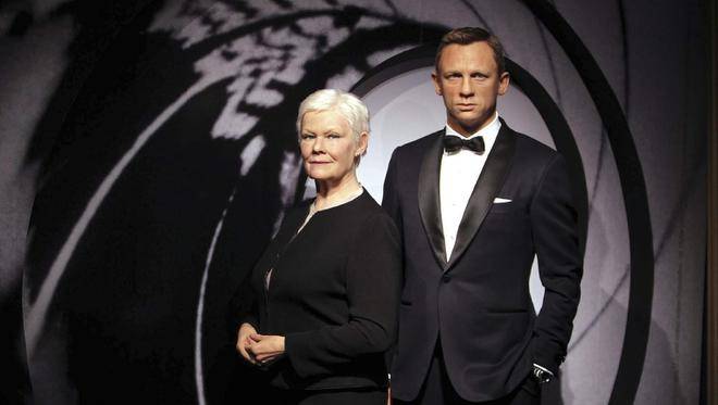Wax models of James Bond movie characters Daniel Craig, right, and Judi Dench appear in a new James Bond 007 type setting at Madame Tussauds wax works in London.