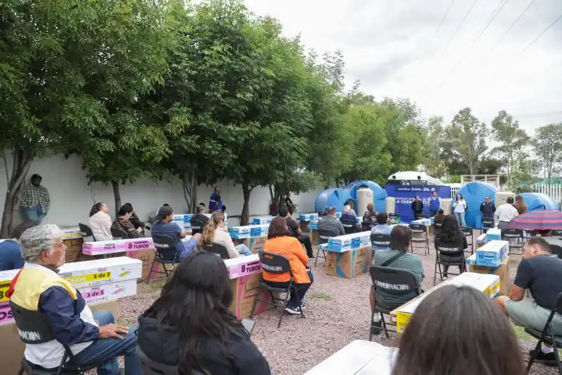 El presidente municipal Leo Montañez estrecha la mano de una beneficiaria durante la entrega de equipamiento para el hogar. A través de la estrategia La Ciudad de tu Vida, las familias acceden a apoyos como calentadores solares con esquemas de subsidio.
